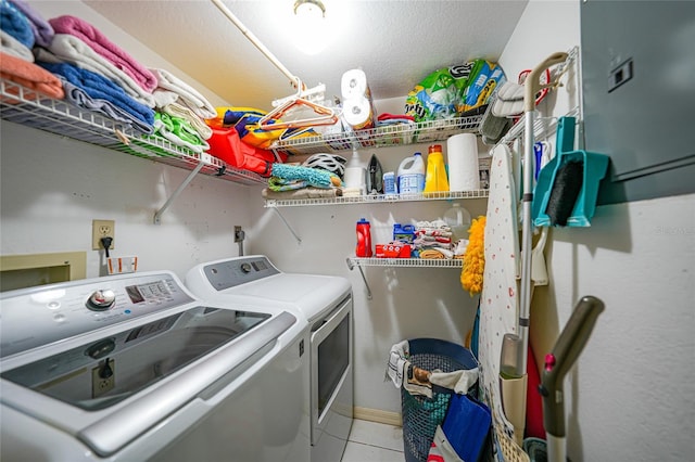 laundry area with light tile patterned flooring and washer and dryer