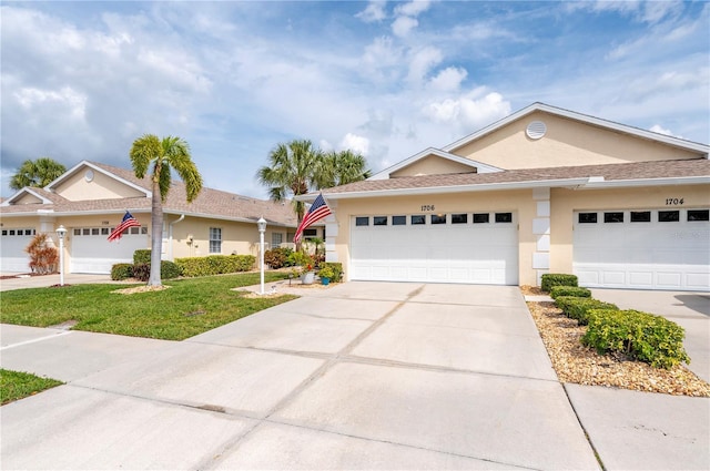 view of front facade with a garage and a front lawn