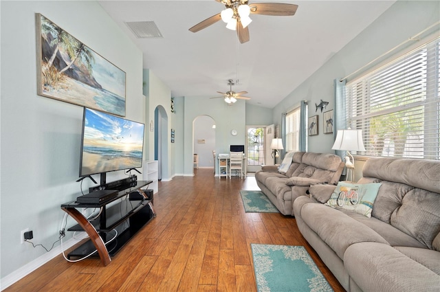 living room featuring hardwood / wood-style flooring, ceiling fan, and vaulted ceiling