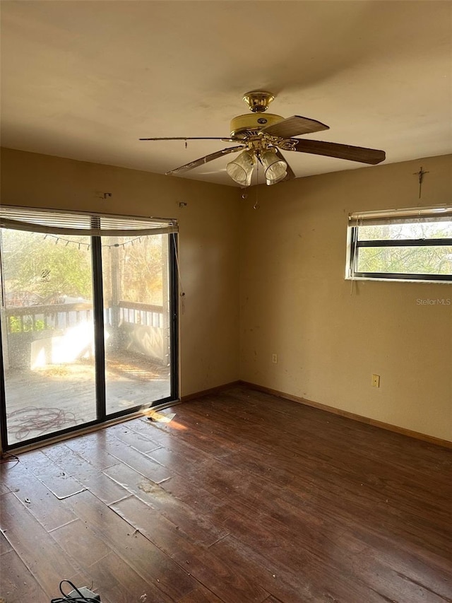 spare room with dark wood-type flooring and ceiling fan