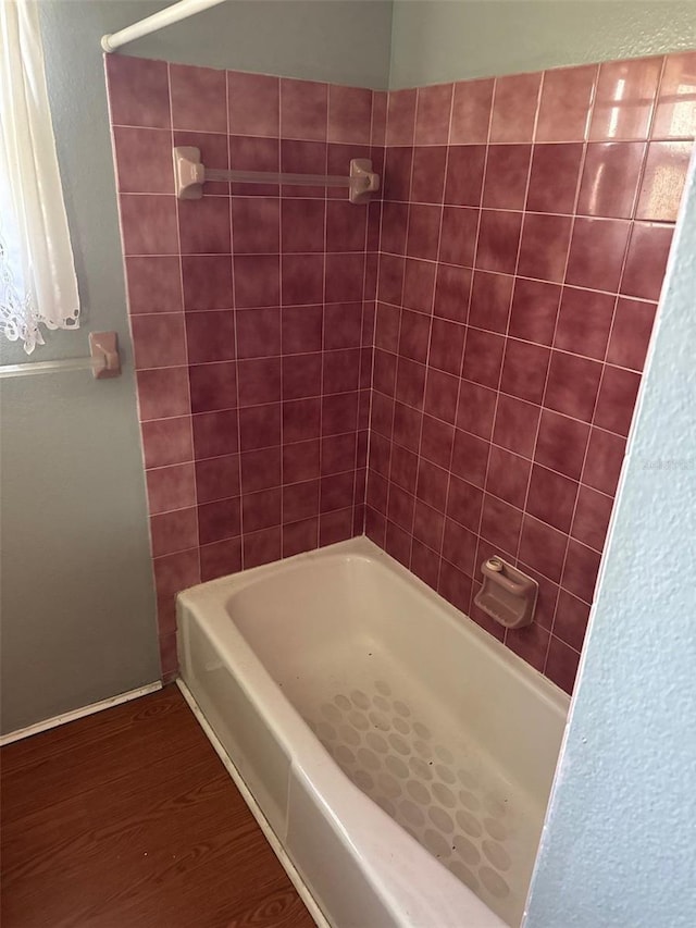 bathroom featuring hardwood / wood-style flooring and shower with separate bathtub