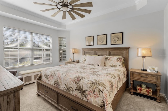 bedroom featuring radiator, ornamental molding, light colored carpet, ceiling fan, and a raised ceiling