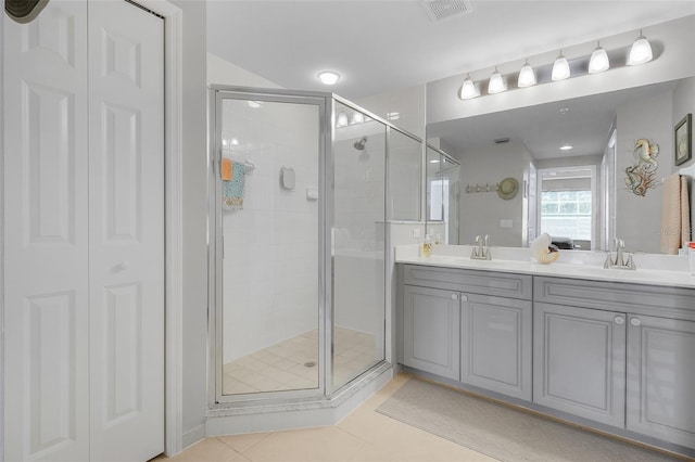 bathroom with vanity, tile patterned floors, and walk in shower