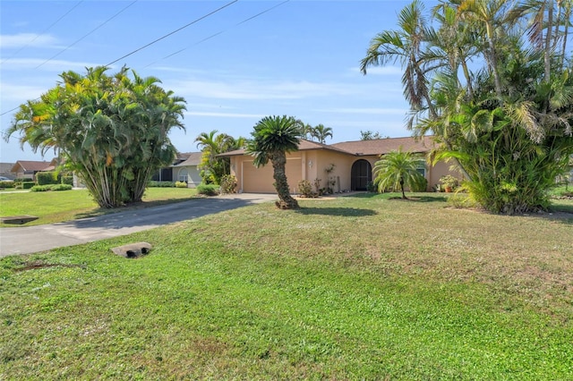 ranch-style home with a garage and a front lawn