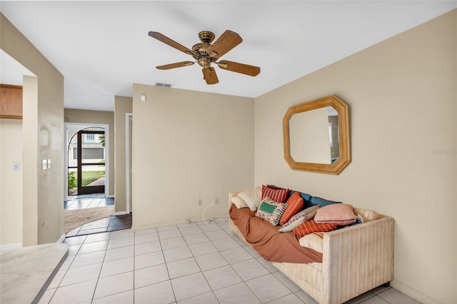 tiled living room featuring ceiling fan