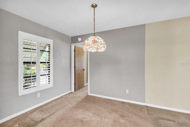 spare room featuring light colored carpet