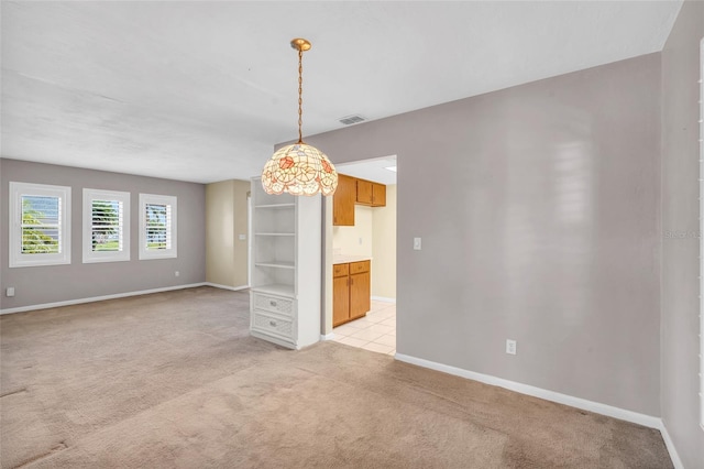 unfurnished room with light colored carpet