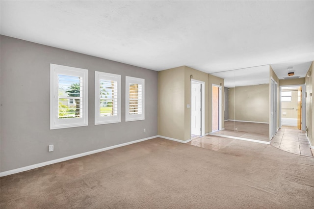 carpeted empty room with a healthy amount of sunlight