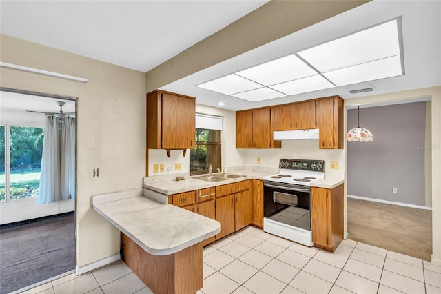 kitchen featuring sink, hanging light fixtures, white range with electric stovetop, light colored carpet, and kitchen peninsula