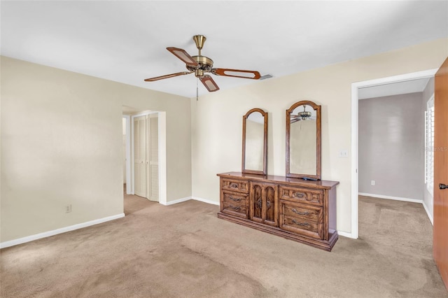 interior space with ceiling fan