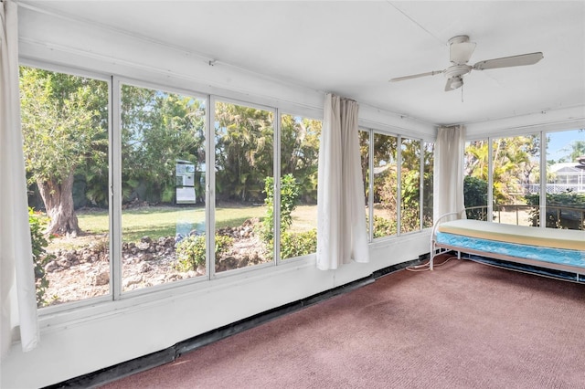 unfurnished sunroom featuring ceiling fan