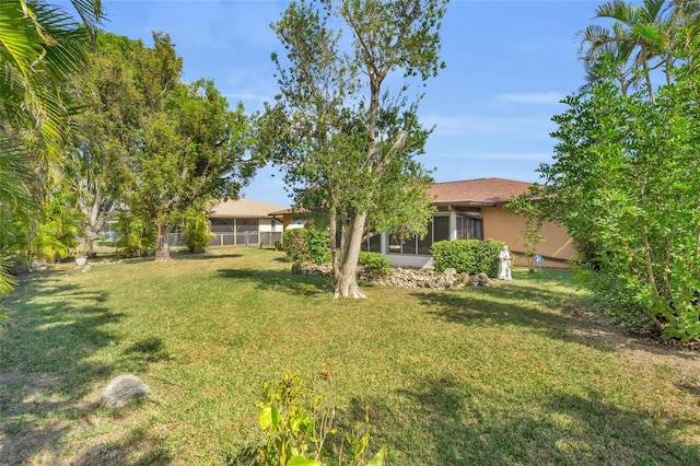 view of yard featuring a sunroom