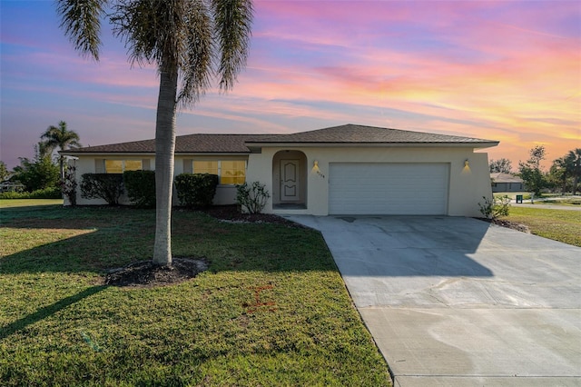 single story home with a yard and a garage