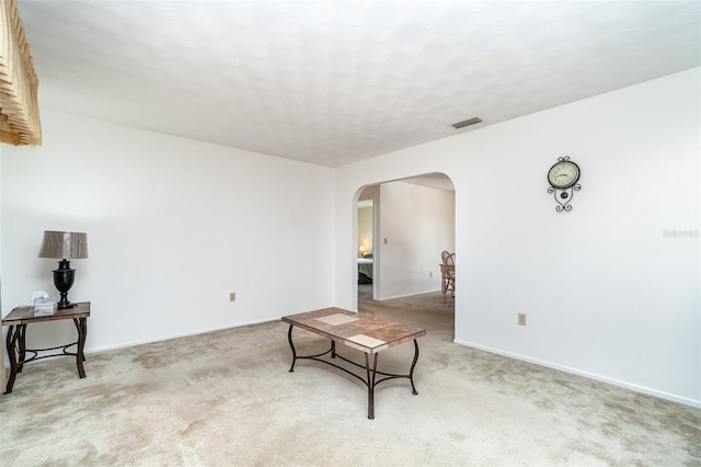 living area featuring light carpet