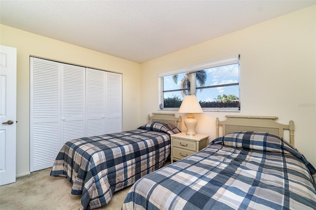 carpeted bedroom featuring a closet and a textured ceiling