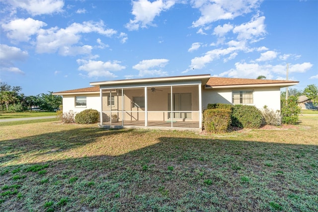 back of property featuring a yard, ceiling fan, and a sunroom