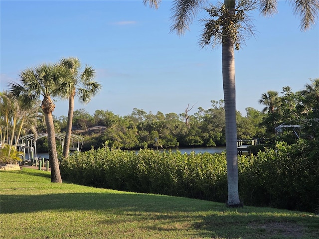 exterior space featuring a water view and a lawn