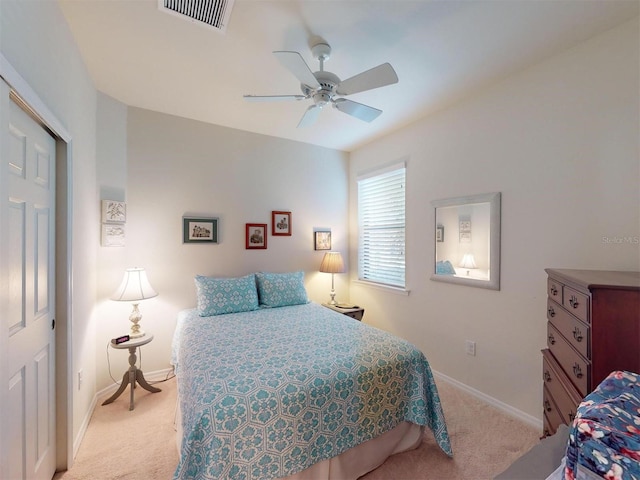 bedroom featuring light carpet and ceiling fan