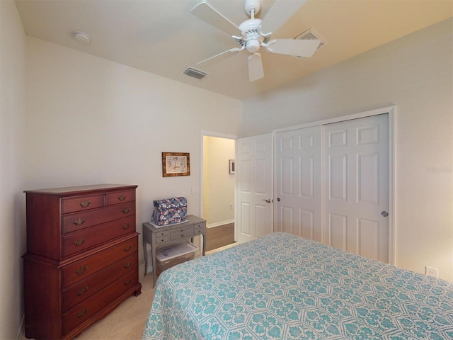 bedroom featuring light carpet, a closet, and ceiling fan