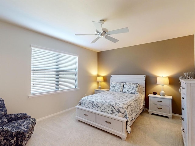 bedroom with light carpet and ceiling fan