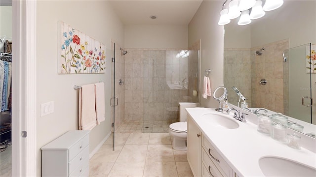 bathroom with vanity, tile patterned floors, toilet, and walk in shower