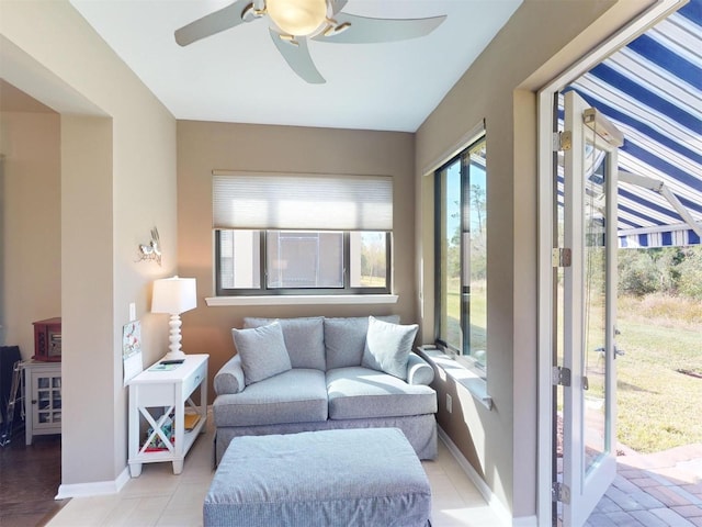 sunroom / solarium featuring ceiling fan