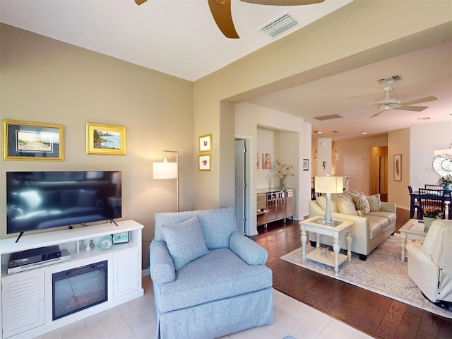 living room featuring ceiling fan and light wood-type flooring