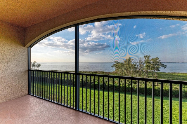 unfurnished sunroom with a water view