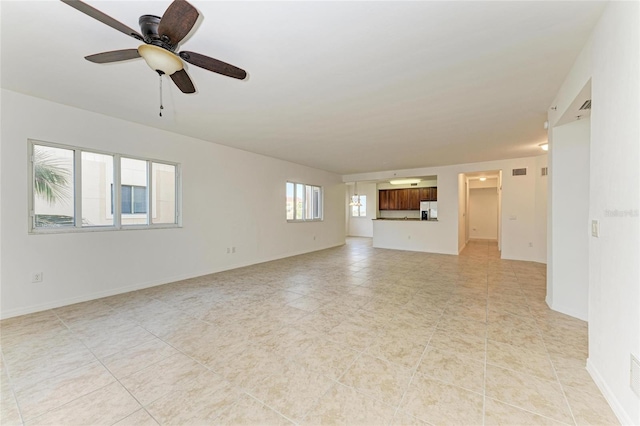 unfurnished living room with ceiling fan and light tile patterned flooring