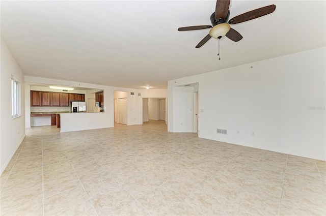 unfurnished living room featuring ceiling fan