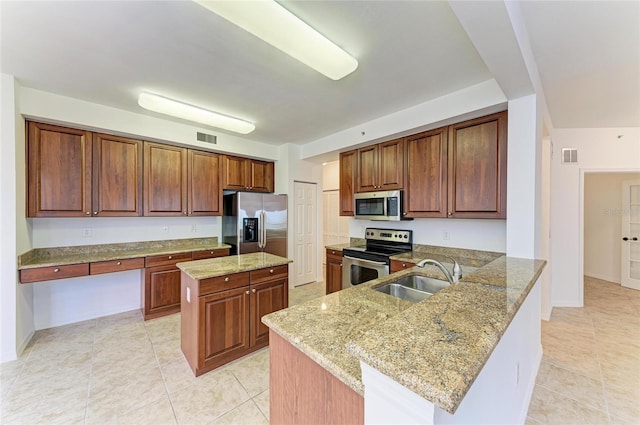 kitchen with sink, appliances with stainless steel finishes, a center island, light stone counters, and kitchen peninsula