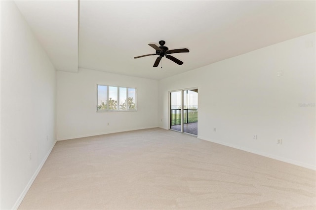 empty room featuring light colored carpet and ceiling fan