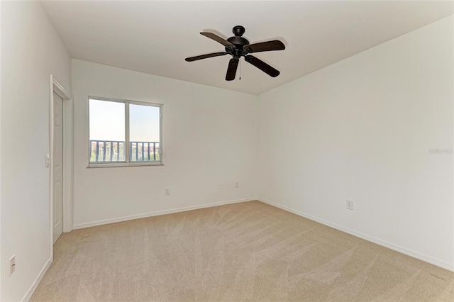 carpeted spare room with ceiling fan