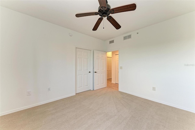 unfurnished bedroom with light carpet and ceiling fan