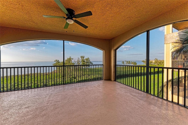 unfurnished sunroom with a water view