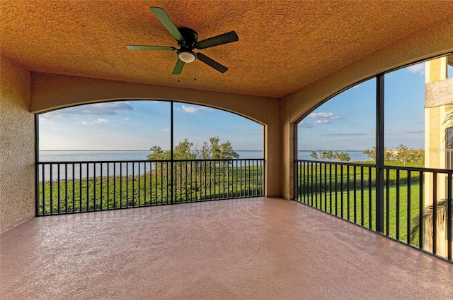 unfurnished sunroom with a water view