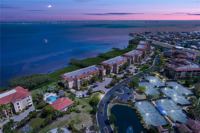 aerial view at dusk with a water view