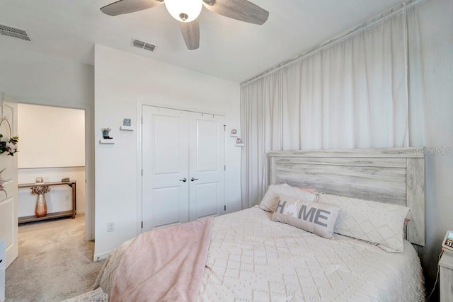 carpeted bedroom featuring ceiling fan and a closet