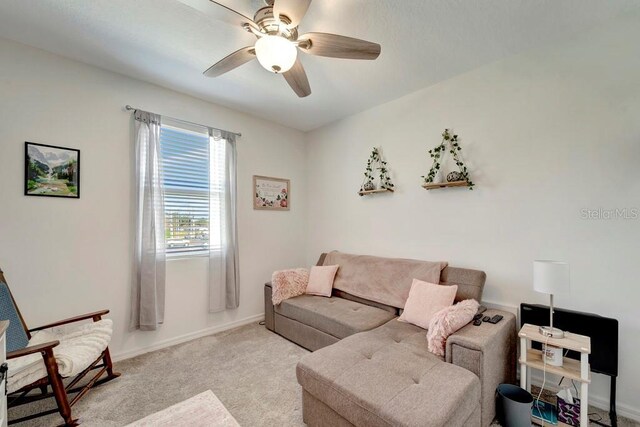 living room with light colored carpet and ceiling fan