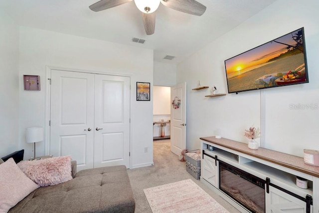 living room with ceiling fan and light carpet