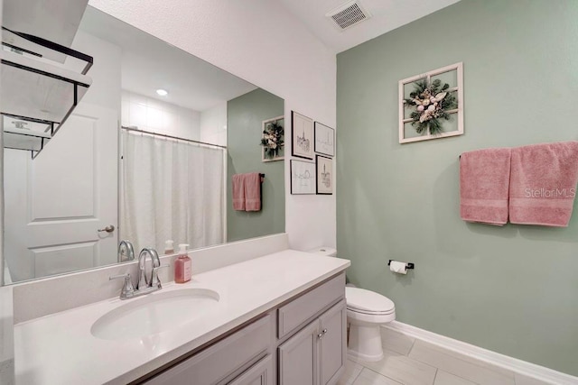 bathroom featuring walk in shower, tile patterned floors, vanity, and toilet