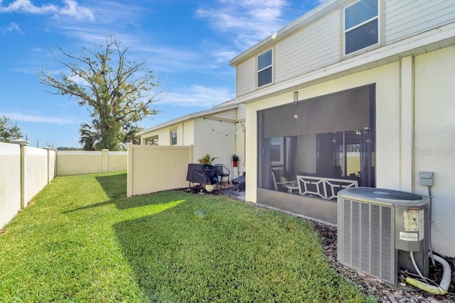 view of yard featuring central AC and a sunroom