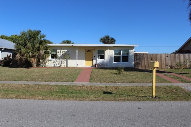 ranch-style house with a front lawn