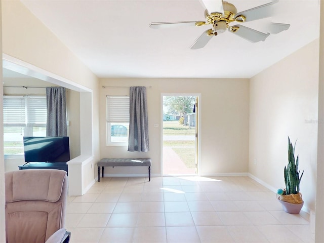 interior space with ceiling fan and light tile patterned floors