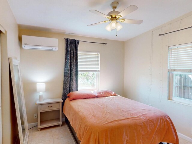 21456 Holdern Ave, Port Charlotte, FL 33952 - tiled bedroom featuring a wall mounted air conditioner and ceiling fan