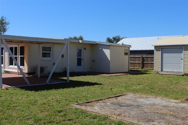 21456 Holdern Ave, Port Charlotte, FL 33952 - rear view of house featuring a patio, central air condition unit, and a lawn