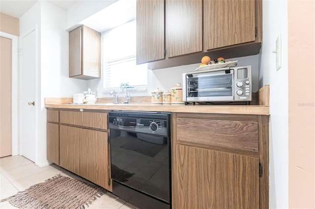 kitchen with dishwasher and light tile patterned flooring