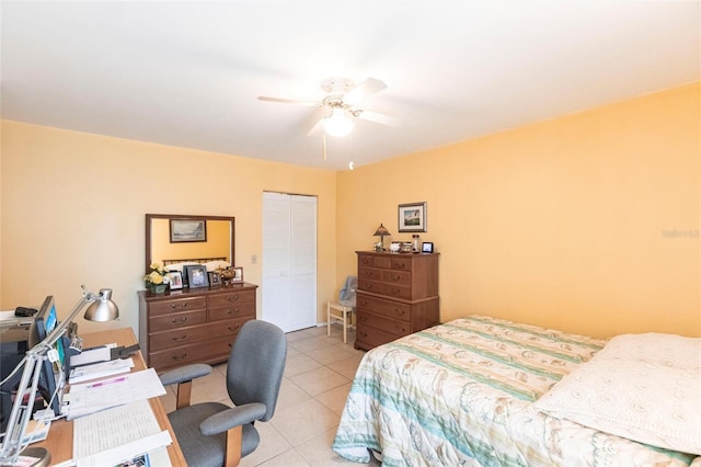 tiled bedroom featuring ceiling fan and a closet