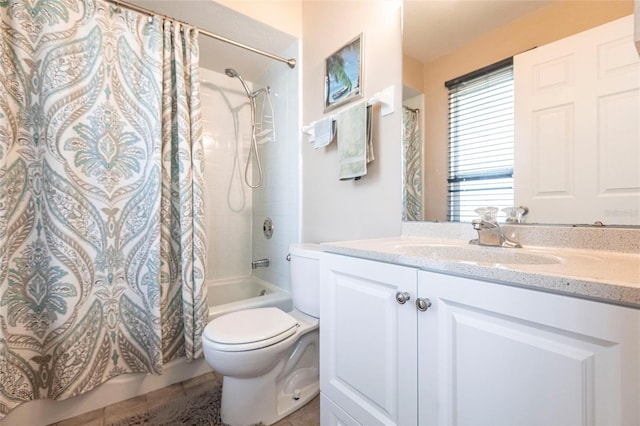 full bathroom with vanity, shower / bath combination with curtain, and toilet