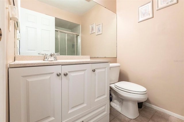 bathroom featuring a shower with door, vanity, tile patterned floors, and toilet